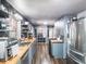 Modern kitchen features shaker cabinets, butcher block countertops, stainless appliances, and an open pantry area at 392 W Minnehaha Ave, Clermont, FL 34711