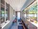 View of the screened sunroom looking toward the backyard and showing the bench and plants at 392 W Minnehaha Ave, Clermont, FL 34711