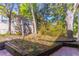 Exterior backyard with greenery, patio and adjacent home with double-hung windows at 410 N Niblick Ln, Lake Mary, FL 32746
