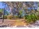 Backyard featuring mature trees, lush landscaping, and a path through the yard at 410 N Niblick Ln, Lake Mary, FL 32746