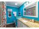 Bathroom featuring vibrant blue walls, granite countertop, and decorative shower curtain at 410 N Niblick Ln, Lake Mary, FL 32746