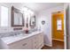 Bright bathroom featuring dual vanities, framed mirrors, modern lighting and wood-look vinyl flooring at 410 N Niblick Ln, Lake Mary, FL 32746