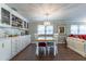 Inviting dining area with stylish chandelier, built-in cabinets, and hardwood floors at 410 N Niblick Ln, Lake Mary, FL 32746