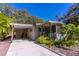 Well-maintained home with a carport, tropical landscaping, and a welcoming screened porch at 410 N Niblick Ln, Lake Mary, FL 32746