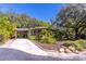 Charming home with lush landscaping, carport, and inviting curb appeal on a sunny day at 410 N Niblick Ln, Lake Mary, FL 32746