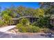 Charming home featuring a carport, mature landscaping, and a screened-in porch for outdoor living at 410 N Niblick Ln, Lake Mary, FL 32746