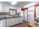 Bright kitchen featuring white cabinetry, granite countertops, and a colorful mosaic backsplash at 410 N Niblick Ln, Lake Mary, FL 32746