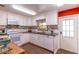 Bright kitchen featuring white cabinetry, granite countertops, and a colorful mosaic backsplash at 410 N Niblick Ln, Lake Mary, FL 32746
