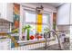 Charming kitchen window with mosaic tile accents, adding a unique and artistic touch to the space at 410 N Niblick Ln, Lake Mary, FL 32746