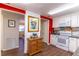 Functional kitchen layout with modern appliances, granite countertops, and bright red accents on the walls at 410 N Niblick Ln, Lake Mary, FL 32746