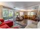 Inviting living room with wood flooring, plush seating, and a sliding door to the outdoors at 410 N Niblick Ln, Lake Mary, FL 32746