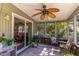 Relaxing screened porch with ceiling fan and comfortable seating overlooking lush landscaping at 410 N Niblick Ln, Lake Mary, FL 32746