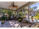 Relaxing screened porch with ceiling fan and comfortable seating overlooking lush landscaping at 410 N Niblick Ln, Lake Mary, FL 32746