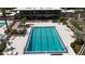 An aerial view of the bright blue swimming pool with lounge chairs and a modern building in the background at 410 N Niblick Ln, Lake Mary, FL 32746