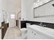 Modern bathroom featuring a stand up shower, vanity sink, and classic black and white theme at 419 Coventry Rd, Davenport, FL 33897