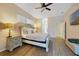 Bright bedroom featuring wood floors, ceiling fan, a king bed, and neutral color scheme at 419 Coventry Rd, Davenport, FL 33897