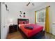 Bright bedroom featuring wood floors, ceiling fan, and a full bed, with themed decor at 419 Coventry Rd, Davenport, FL 33897