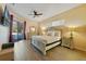 Spacious bedroom featuring wood floors, ceiling fan, king bed, and sliding glass doors to the lanai at 419 Coventry Rd, Davenport, FL 33897