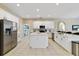 Modern kitchen featuring a center island, stainless steel appliances, and white cabinetry at 419 Coventry Rd, Davenport, FL 33897