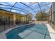 Sparkling screened-in pool with an attached hot tub and a covered lanai at 419 Coventry Rd, Davenport, FL 33897