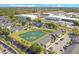Drone shot showcasing the community's layout, pond, buildings, and nearby industrial park at 4314 Pershing Pointe Pl # 4, Orlando, FL 32822