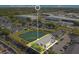 Aerial view of the apartments, pond, parking, and nearby commercial buildings at 4314 Pershing Pointe Pl # 4, Orlando, FL 32822