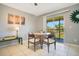 Cozy dining area with table, chairs, and a sliding glass door to a balcony at 4314 Pershing Pointe Pl # 4, Orlando, FL 32822