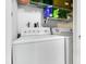 Clean laundry room featuring a washing machine and a dryer with shelving at 4314 Pershing Pointe Pl # 4, Orlando, FL 32822