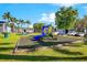 Enjoy outdoor recreation at the community's playground with slide, seating, and landscaping at 4314 Pershing Pointe Pl # 4, Orlando, FL 32822