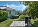 Spacious backyard featuring a grill area, mature trees, and manicured landscaping, providing a private outdoor retreat at 504 Sonata Ct, Winter Springs, FL 32708