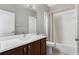 Clean bathroom featuring a dark wood vanity with white countertop and a shower-tub with curtain at 504 Sonata Ct, Winter Springs, FL 32708