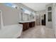 Bright bathroom showcasing a dual sink vanity, a walk-in shower, a soaking tub and a walk-in closet at 504 Sonata Ct, Winter Springs, FL 32708