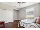 Neutral bedroom featuring a ceiling fan, hardwood floors, a closet, and large window providing natural light at 504 Sonata Ct, Winter Springs, FL 32708