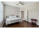 Neutral bedroom featuring a ceiling fan, hardwood floors, a comfy bed, and bright natural light at 504 Sonata Ct, Winter Springs, FL 32708