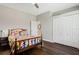 Bright bedroom featuring dark wood floors, a closet, a ceiling fan, and a colorful bed at 504 Sonata Ct, Winter Springs, FL 32708