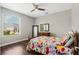 Comfortable bedroom featuring hardwood floors, a ceiling fan, and a brightly patterned comforter on the bed at 504 Sonata Ct, Winter Springs, FL 32708