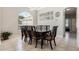 Formal dining room with large window, decorative light fixture, and seating for ten at 504 Sonata Ct, Winter Springs, FL 32708