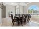 Dining room with large windows, a decorative chandelier, and seating for eight at 504 Sonata Ct, Winter Springs, FL 32708