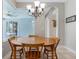 Cozy dining area featuring a round wood table with chairs, tile flooring, and natural light from the adjacent screened-in lanai at 504 Sonata Ct, Winter Springs, FL 32708