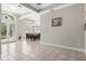 Open dining room with a decorative chandelier, neutral tile floors, and view to front yard at 504 Sonata Ct, Winter Springs, FL 32708
