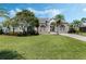 Attractive single-story home featuring a well-maintained lawn, stone accents, mature trees, and an arched entry at 504 Sonata Ct, Winter Springs, FL 32708