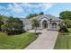 Charming single-story home with arched entryway, stone accents, lush landscaping, and a well-manicured front yard at 504 Sonata Ct, Winter Springs, FL 32708