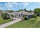 Beautiful home with an arched entryway, stone accents, and well-manicured landscaping at 504 Sonata Ct, Winter Springs, FL 32708