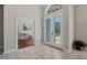 Bright foyer with tile flooring, double front doors with glass panels, and an open view of a study at 504 Sonata Ct, Winter Springs, FL 32708