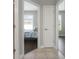 Hallway featuring a view into a bedroom with a bed, with hardwood floors and a window with blinds at 504 Sonata Ct, Winter Springs, FL 32708