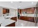 Modern kitchen with stainless steel appliances, white quartz countertops and dark wood cabinetry at 504 Sonata Ct, Winter Springs, FL 32708