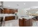 Modern kitchen with stainless steel appliances, central island with bar seating, and a seamless view into the living area at 504 Sonata Ct, Winter Springs, FL 32708