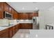 Modern kitchen with stainless steel appliances, lots of dark wood cabinetry and white quartz countertops at 504 Sonata Ct, Winter Springs, FL 32708