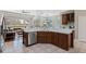 Open kitchen layout with stainless steel appliances, quartz countertops, and a view into the adjacent living space at 504 Sonata Ct, Winter Springs, FL 32708