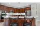 Kitchen island with white countertops and dark wood cabinets, complemented by modern stainless steel appliances at 504 Sonata Ct, Winter Springs, FL 32708